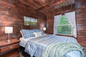 Sleep peacefully in this serene woodland bedroom 🌙🛏️ Surrounded by warm wood tones and soft linens, you’ll wake up to calming forest views just outside your window 🌲✨