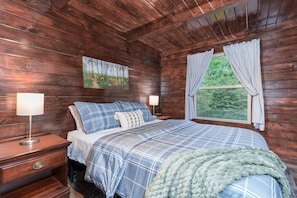 Sleep peacefully in this serene woodland bedroom 🌙🛏️ Surrounded by warm wood tones and soft linens, you’ll wake up to calming forest views just outside your window 🌲✨