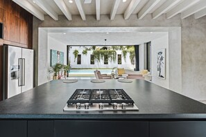 Floor to ceiling glass doors open for true indoor/outdoor living