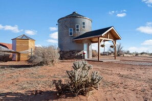 Your charming desert clubhouse awaits inside The Silo. Welcome to the American Southwest! Pictured: Silo + Hammock with private outhouse building to the left