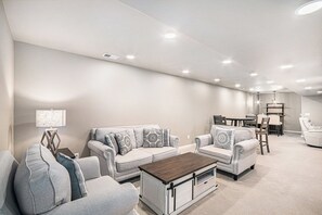The ground-floor family room offers a cozy setup with flexible space for groups.