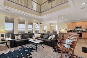Bright, airy, and welcoming—this open-concept living room is perfect for gathering, relaxing, and enjoying the view.
