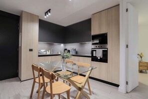 Sleek and modern kitchen with stylish dining area, perfect for enjoying meals and entertaining guests.