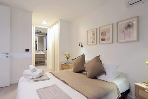 Relax in this serene bedroom with soft tones and an ensuite bathroom, perfect for unwinding after a day of exploring.