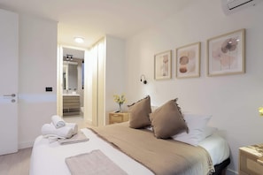 Relax in this serene bedroom with soft tones and an ensuite bathroom, perfect for unwinding after a day of exploring.