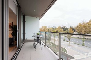 Enjoy a cozy balcony retreat with urban views, perfect for morning coffee or evening relaxation.
