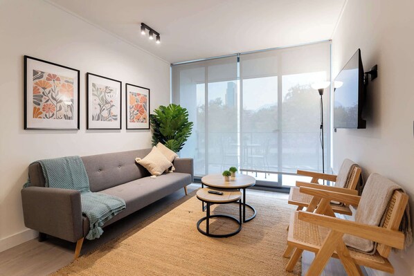 Bright and inviting living room with stylish decor, perfect for relaxation and enjoying the view.