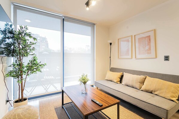 Bright and cozy living room with modern decor and large windows for natural light.