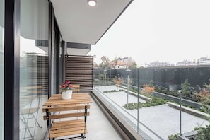 Relax on your private balcony with a charming view of the landscaped courtyard, perfect for morning coffee or evening relaxation.