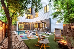 Backyard Oasis With Pool, Fire Pit, And Cozy Lounge Area