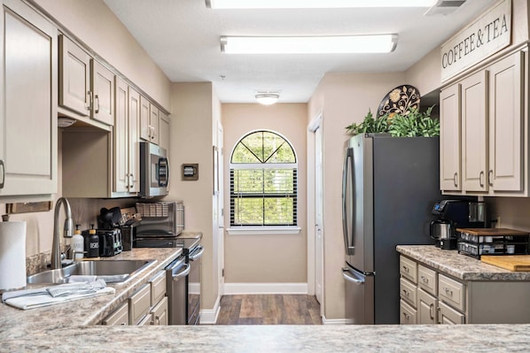 The inviting kitchen offers ample space & every home comfort