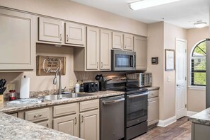 The inviting kitchen offers ample space & every home comfort