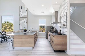 The kitchen is a chef's dream, equipped with top-of-the-line appliances and sleek countertops, making it perfect for entertaining.