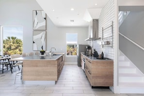 The kitchen is a chef's dream, equipped with top-of-the-line appliances and sleek countertops, making it perfect for entertaining.