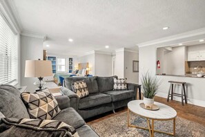 A sofa bed and a love seat in a spaction living area.