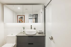 Stylish bathroom with large mirror and elegant vanity.