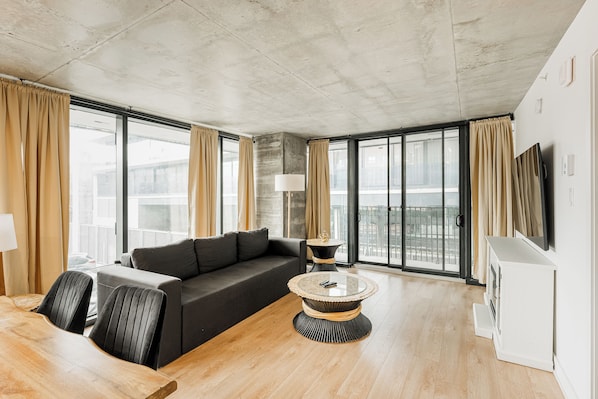 Bright living room with floor-to-ceiling windows and modern decor.