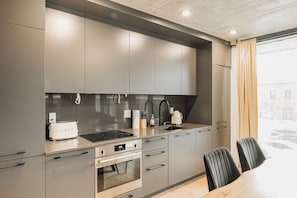 Sleek kitchen with built-in appliances and under-cabinet lighting.