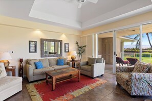 Gather with family and friends in this stylish open concept space with tropical textures and patio access.