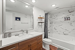 You feel a sense of calm as you enter the bathroom, where the thoughtful design and high-quality materials create a serene environment.