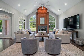Spacious primary living room with vaulted ceilings and lots of natural light. 86" TV and Sonos sound system