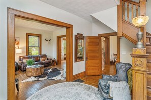 Beautiful and open entry with original wood flooring and trim.