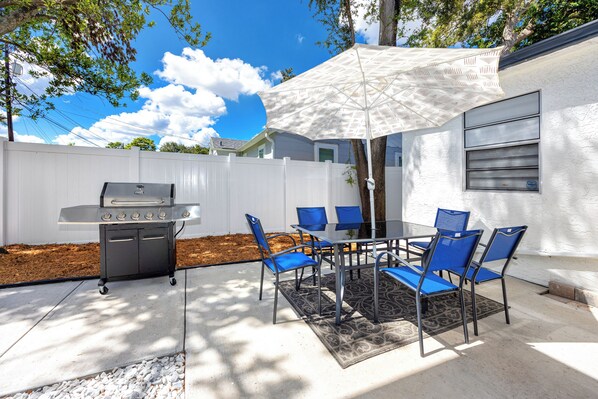 Private fenced outdoor area with grill
