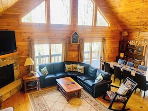 Open and bright living room looking out over woods.