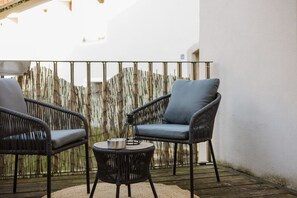 Comfortable outdoor chairs and table create the perfect spot for your morning coffee or evening glass of wine.