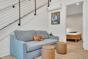 This smartly designed space connects the living room to the bedroom, offering both comfort and privacy for couples or small groups.