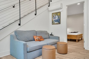 This smartly designed space connects the living room to the bedroom, offering both comfort and privacy for couples or small groups.