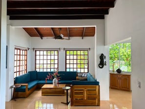 Bright living room with custom teak furniture and ocean views
