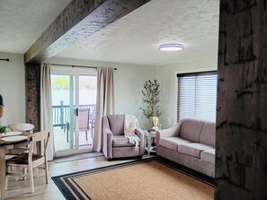 Comfy furniture in the living room includes sofa, loveseat and stationary chair