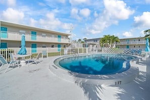 spacious pool with plenty of chairs and seating.