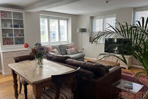 A stylish living room with comfy sofas, and great views of the gardens.