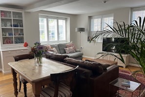 A stylish living room with comfy sofas, and great views of the gardens.