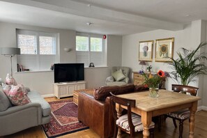 A stylish living room with comfy sofas, and great views of the gardens.