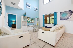 Step into a bright open-concept living room designed for comfort and privacy. Whether you're relaxing with loved ones or hosting a movie night, the airy layout and stylish decor make it feel like your own personal retreat.