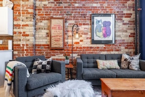 Relax under soaring ceilings surrounded by exposed brick, soft textiles, and curated northern décor — a cozy spot after a day at the Stratford Festival.
