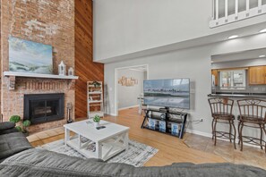 The brick fire place and Flat Screen TV make for the perfect cozy night in.