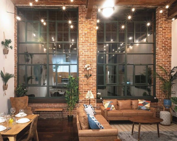 12-ft windows are just gorgeous, string lights in main living area create a cozy ambiance 