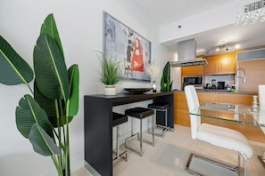 Gather around the dining table for four, perfect for meals, games, or enjoying a glass of wine.