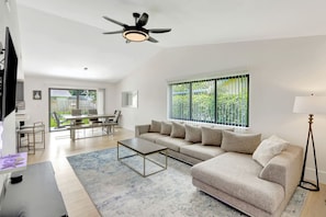 Spacious living room with cozy seating and smart TV.