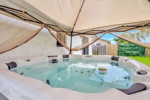 Relax and unwind in your private backyard hot tub.
