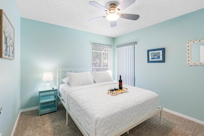 This inviting bedroom features a plush queen-size bed, offering a spacious and cozy sleeping experience for solo travelers, couples, or anyone seeking a peaceful night's rest.
