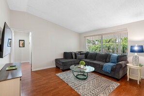 Complementing the entertainment setup is a luxurious lounging couch, crafted with high-density foam cushions that provide an ideal balance of support and softness.