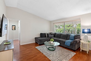 Complementing the entertainment setup is a luxurious lounging couch, crafted with high-density foam cushions that provide an ideal balance of support and softness.