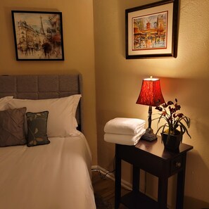 Enjoy this Paris themed room with a queen bed, desk, and sitting area.