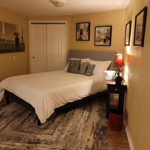 Enjoy this Paris themed room with a queen bed, desk, and sitting area.
