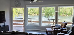 Living room has big picture windows & door to deck.